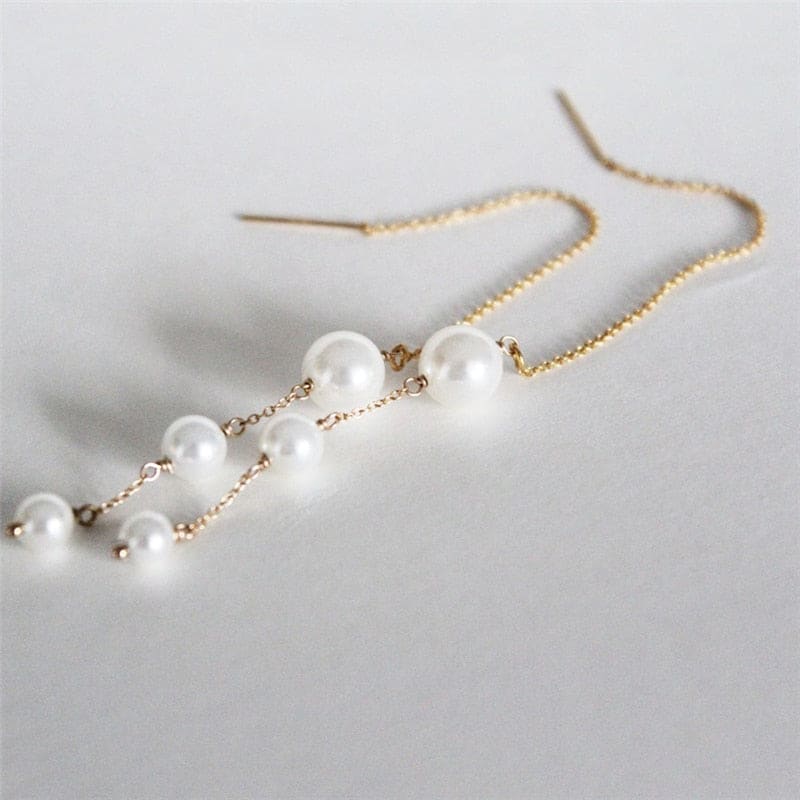 Boucle d&#39;oreille chaine traversante en or avec perle