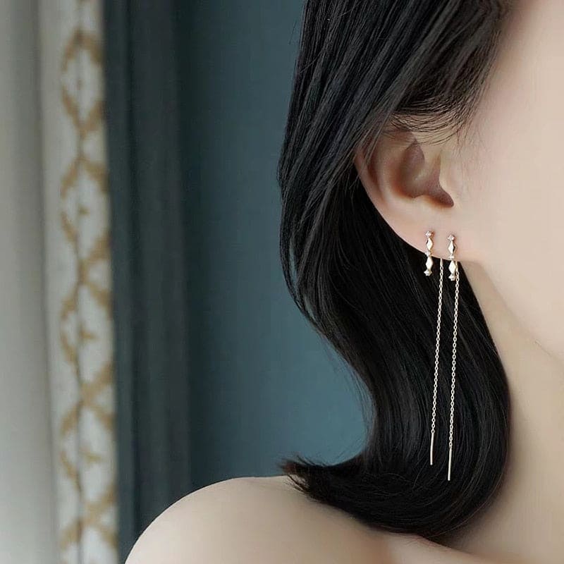 Boucle d'oreille chaine traversante losange doré